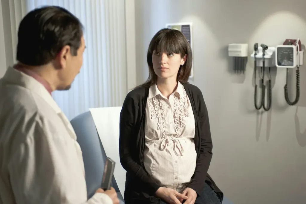 A Pregnant Woman Talking to a Doctor About Her Pregnancy