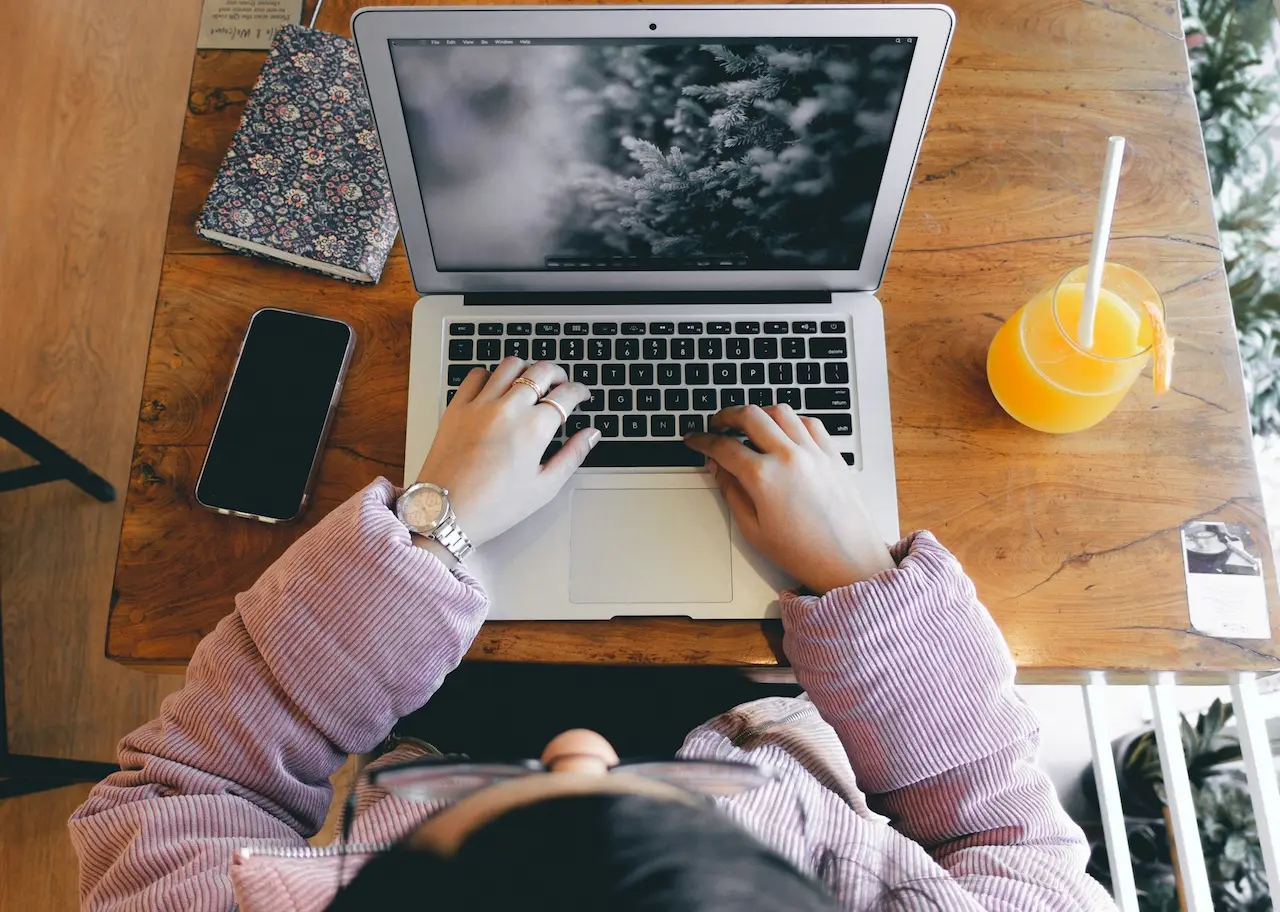 Woman Sitting and Working in Front of a Laptop