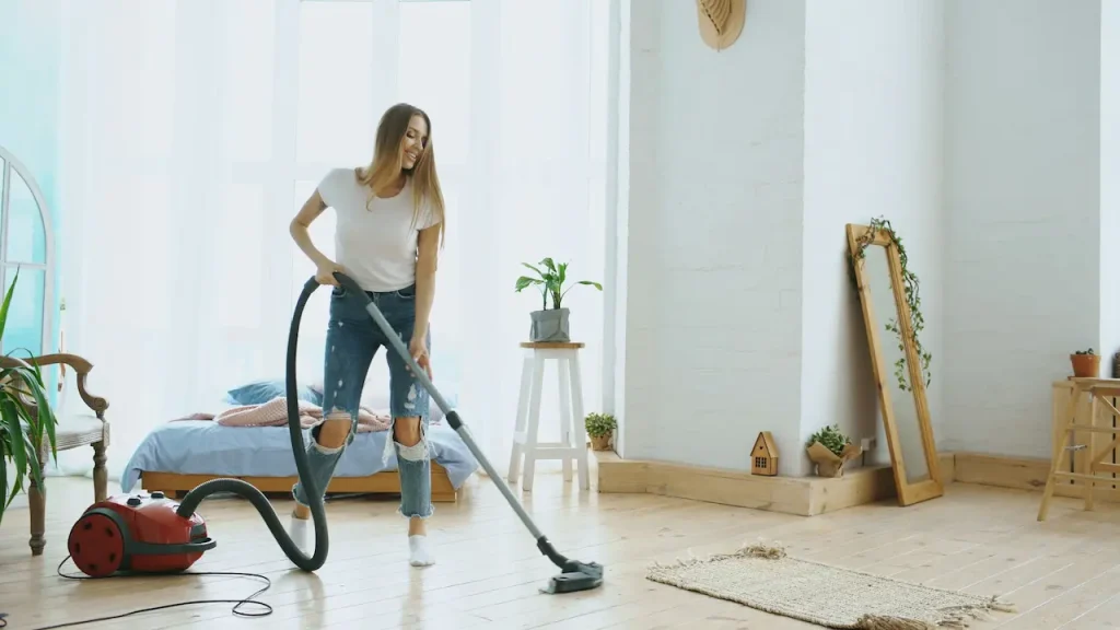 Woman Cleaning Her House with a Vacuum Cleaner 